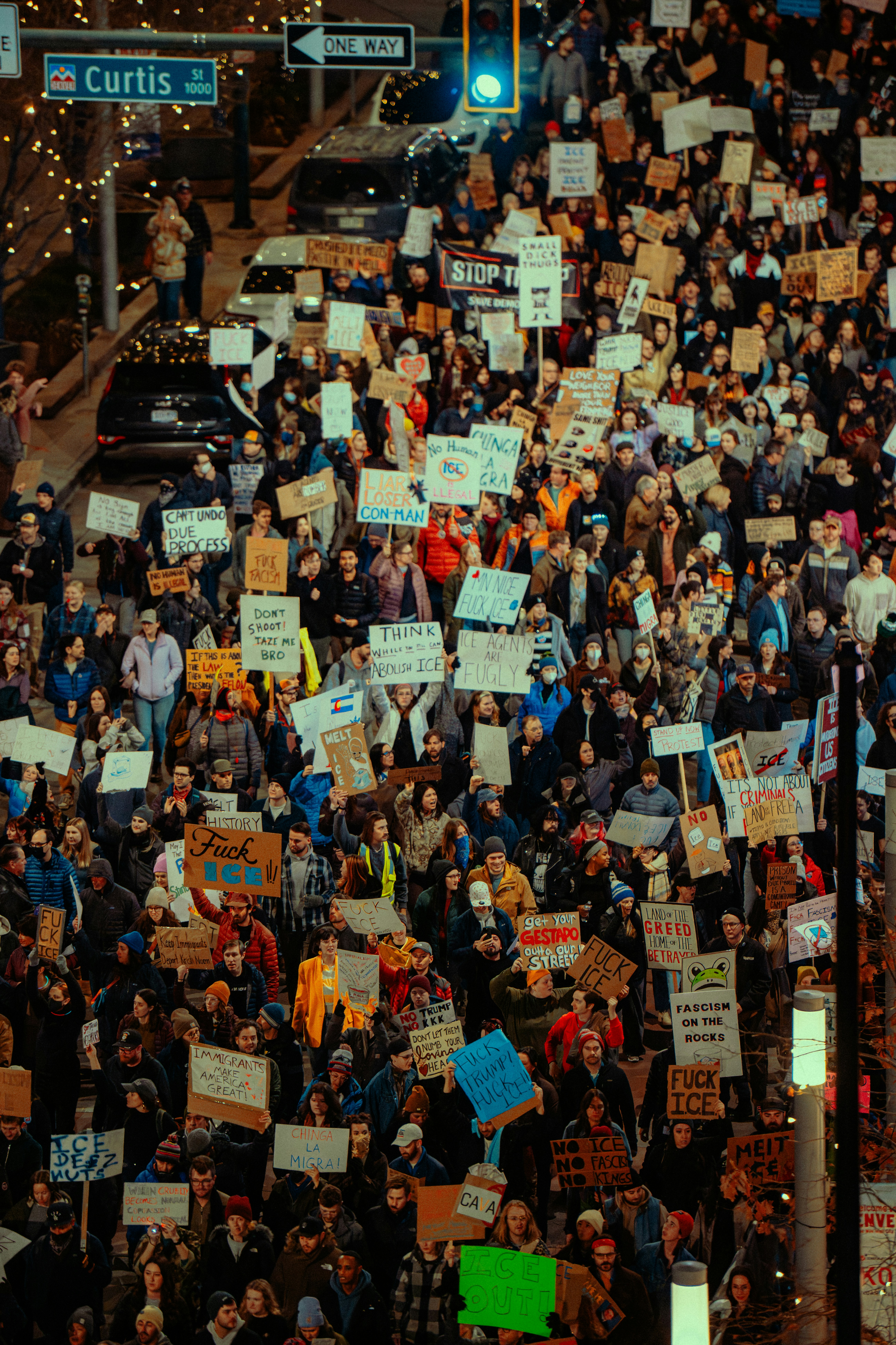 Protest crowd filling a city street at night
