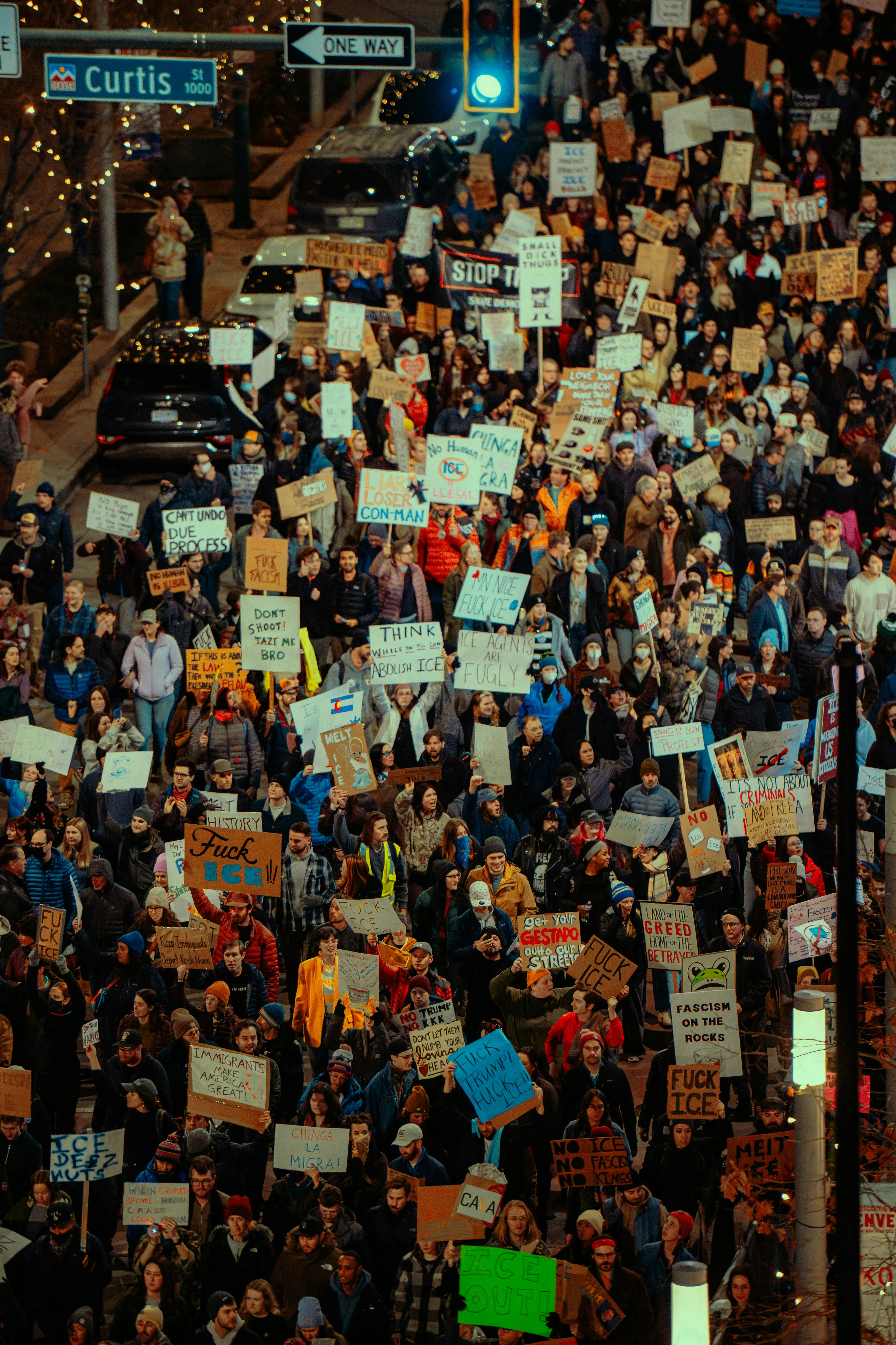 Protest crowd filling a city street at night