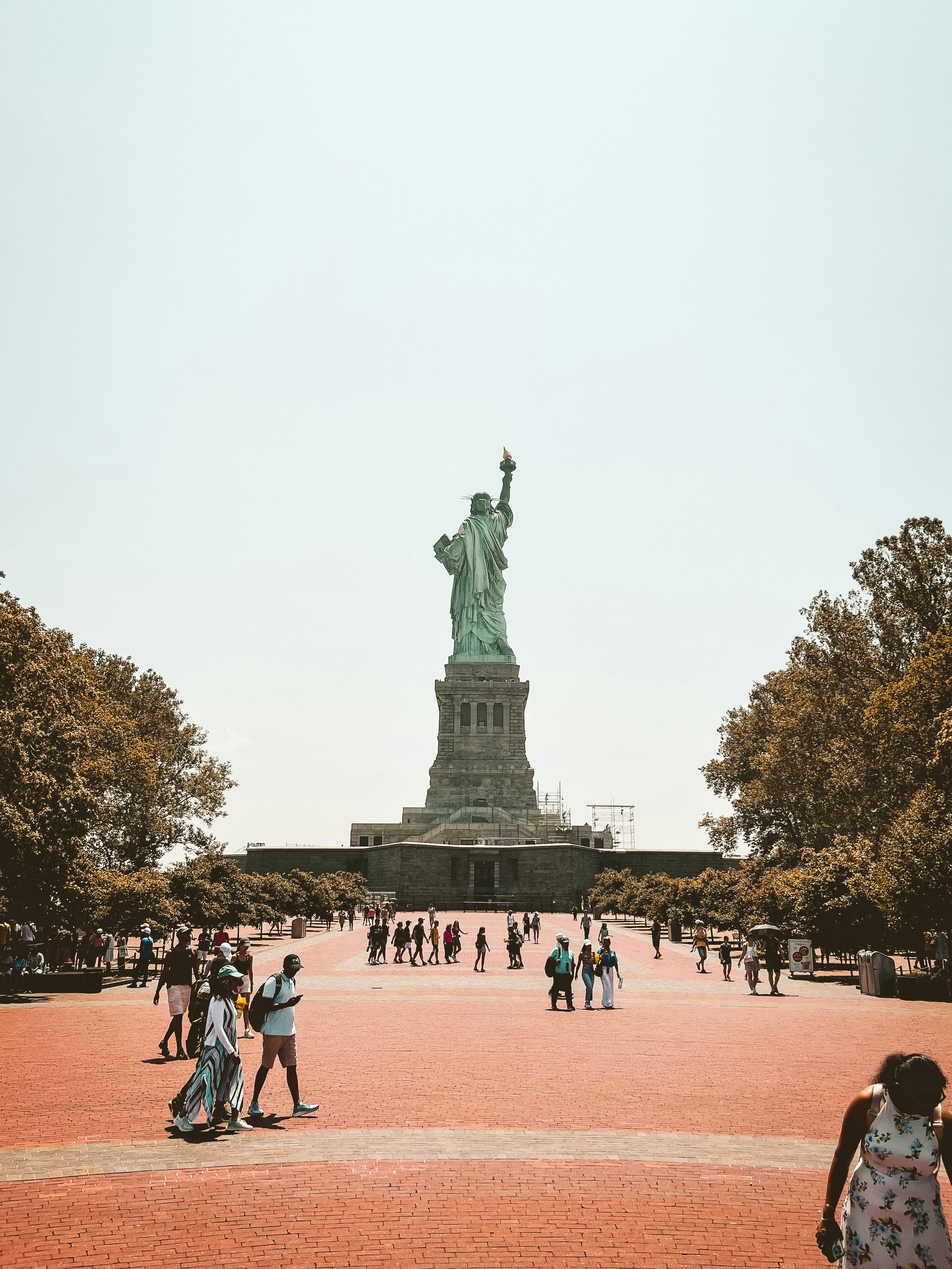 Statue of Liberty seen from the plaza with visitors