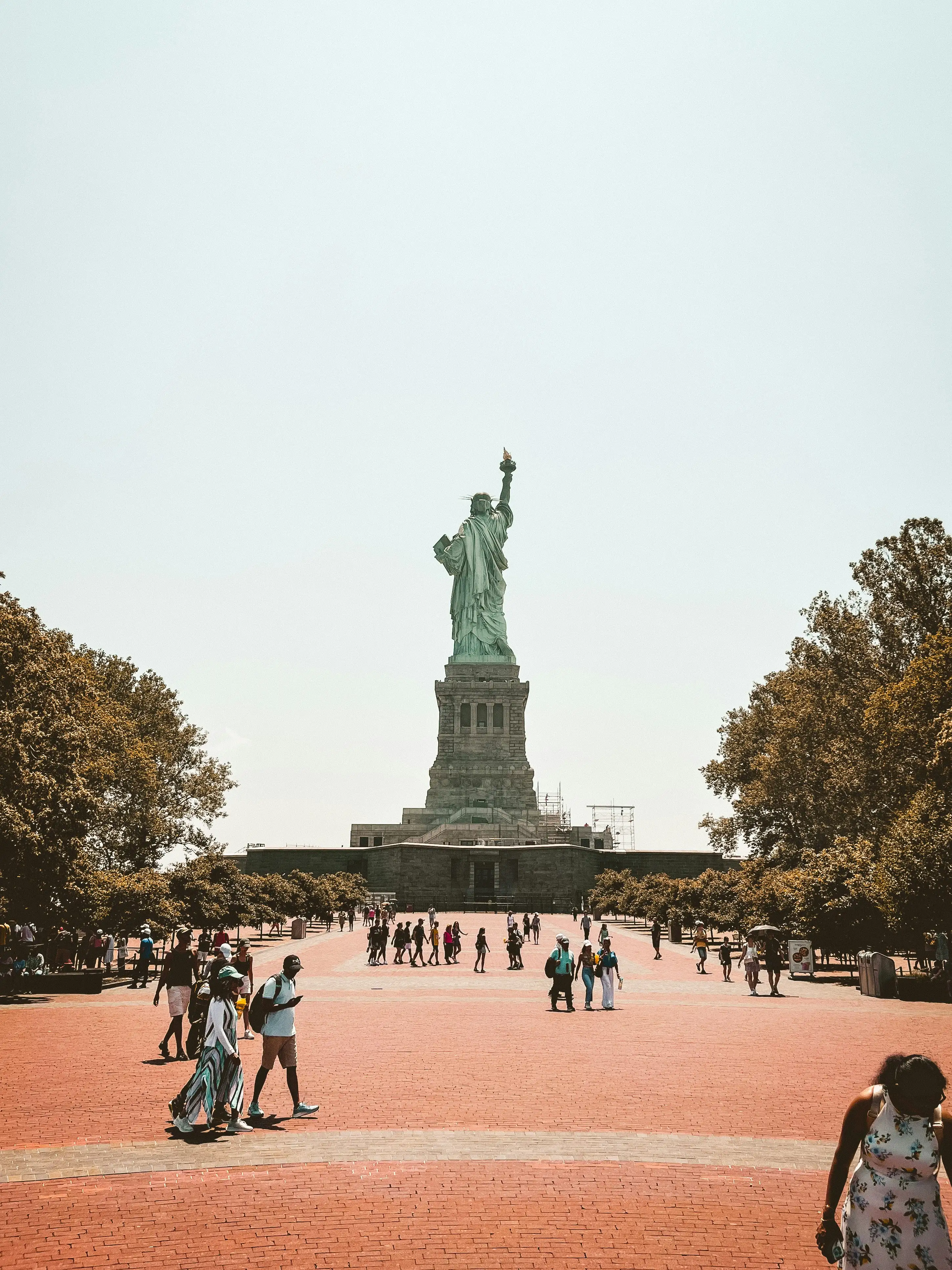 Statue of Liberty seen from the plaza with visitors